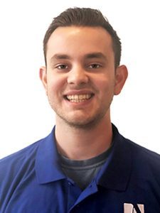 Jack, our Systems Engineer, is directly facing the camera with a bright smile and wearing a blue ArcSource polo shirt.